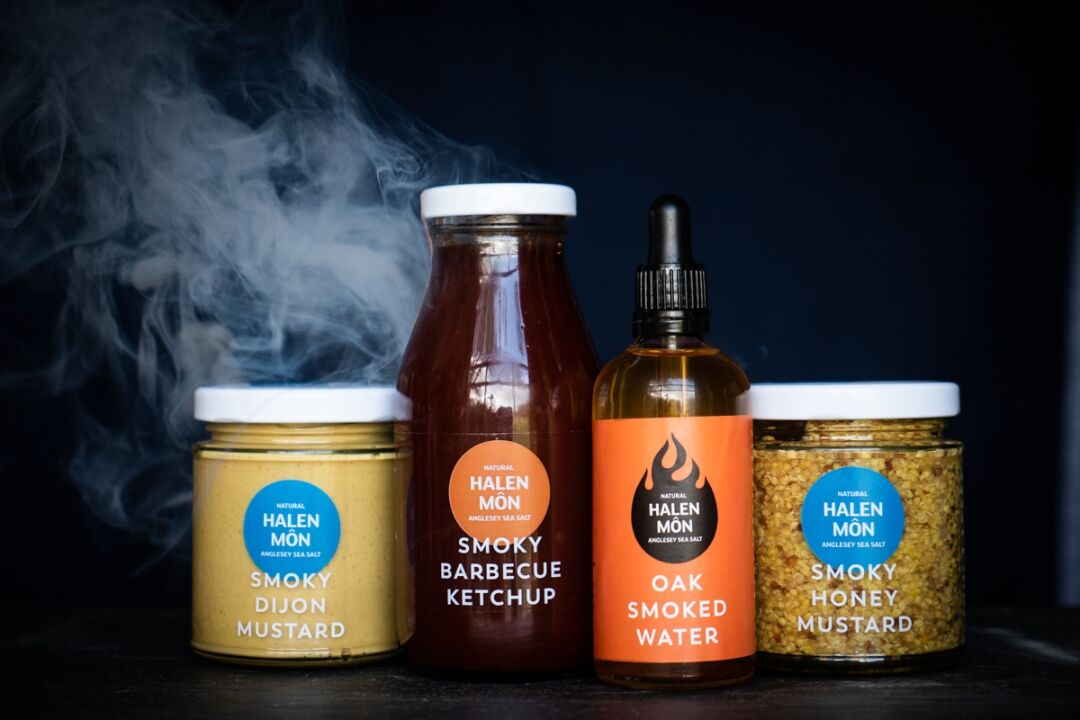 A selection of luxury condiments and a bottle of oak smoked water from our artisan food company