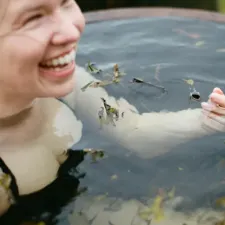 A happy lady enjoying a seaweed soak detox