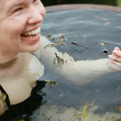 A happy lady enjoying a seaweed soak detox